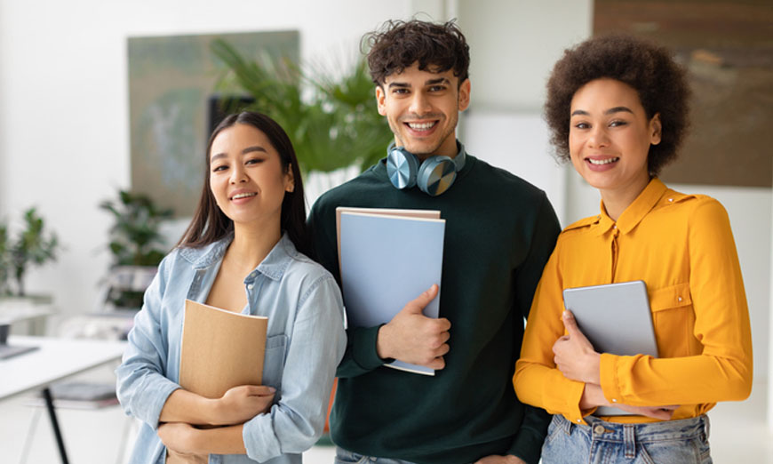 Grupo-de-estudiantes-sonriendo-y-sosteniendo-sus-agendas.